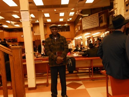 Serge Etele at the Chabad headquater in Brooklyn for Mincha prayer and study. (Photo credit: Rabbi Gerald Sussman)