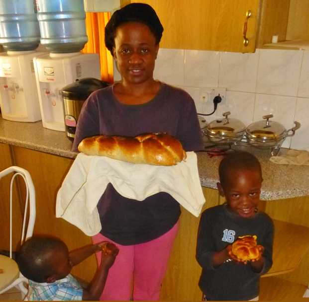 Success. Brenda shows off her beautiful challah, the result of her first lesson in challah baking. Shlomo and Aviv who joined in the fun looked pleased with their efforts (Photo by Mickey Feinberg)