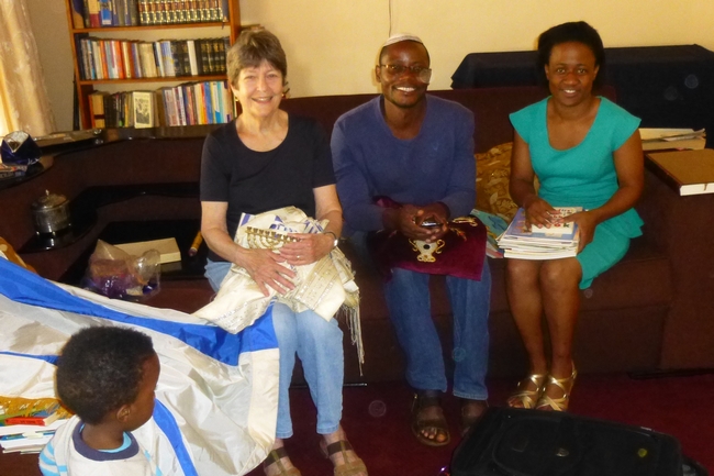Gifts from Boston. Mickey delivers Jewish ritual objects to Brenda and Modreck collected by Kulanu Board member Judy Manelis for the Lemba Community House (Photo courtesy of Mickey Feinberg)
